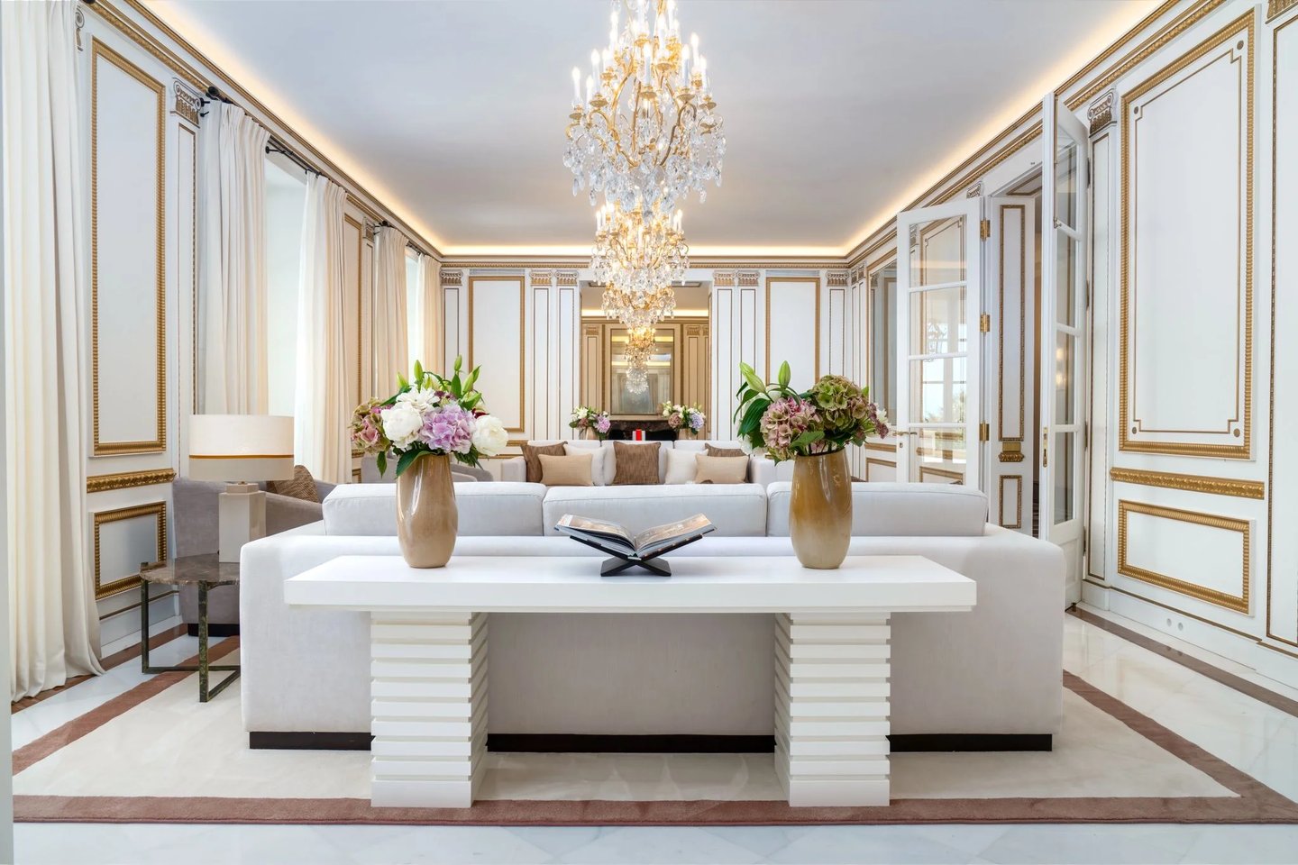 Ornate reception room with gold detailing and chandelier