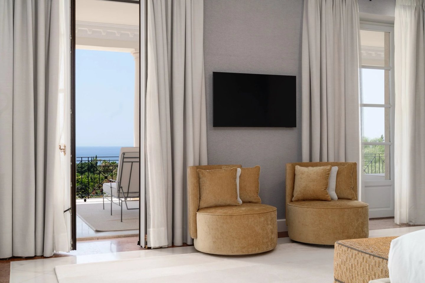 Bedroom lounge with balcony access and distant sea view