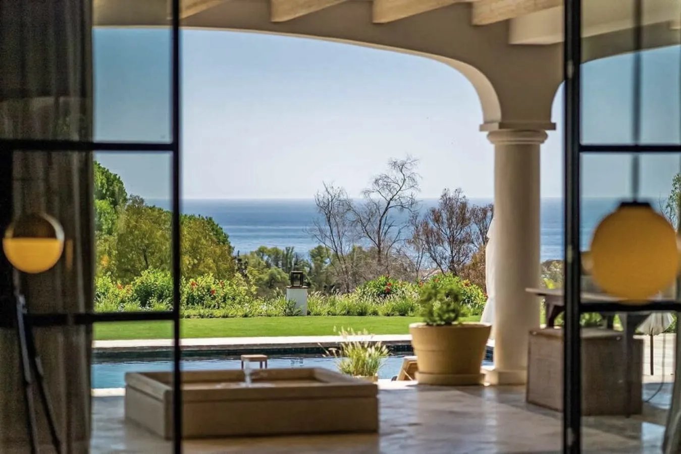 Covered terrace with pool and sea views