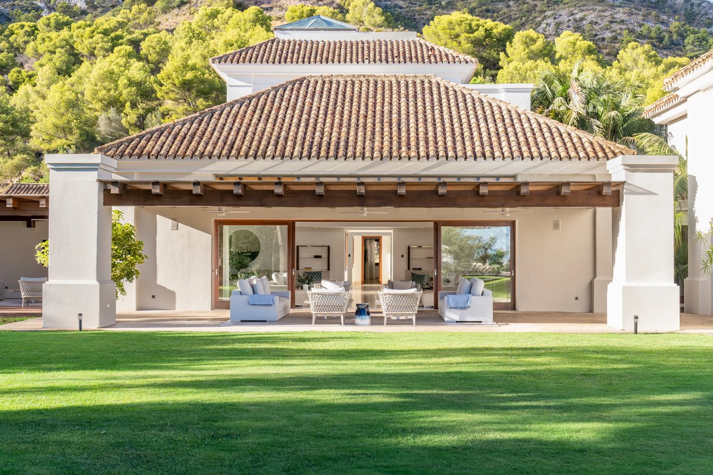 Covered terrace lounge with sliding glass doors
