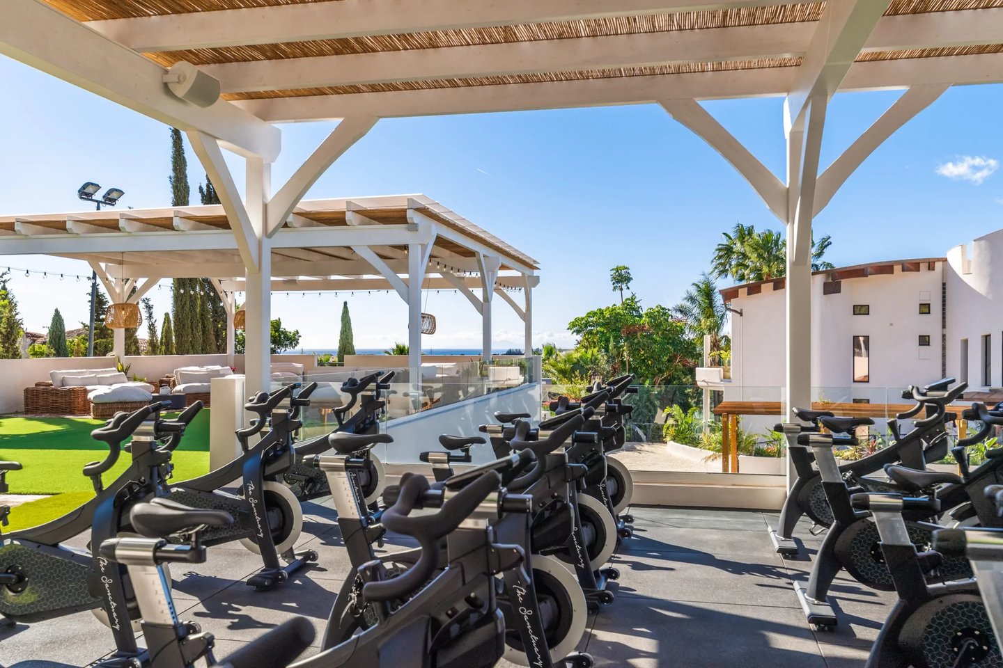 Rooftop spinning studio with sea and garden views