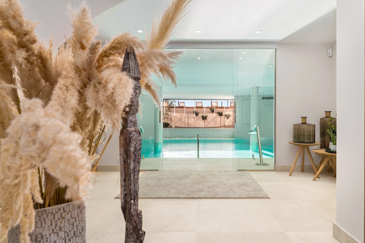 Indoor spa pool with glass wall and relaxation area