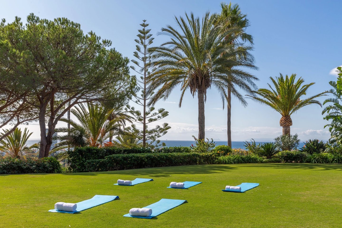 Lawn set for wellness sessions with Mediterranean views