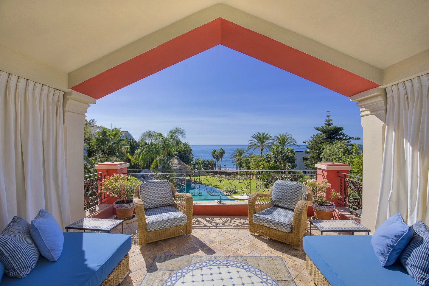 Covered terrace overlooking the beachfront gardens and Mediterranean Sea