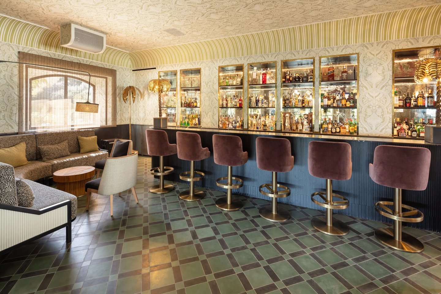 Cocktail bar at Villa La Gratitud with velvet stools and vintage-inspired design