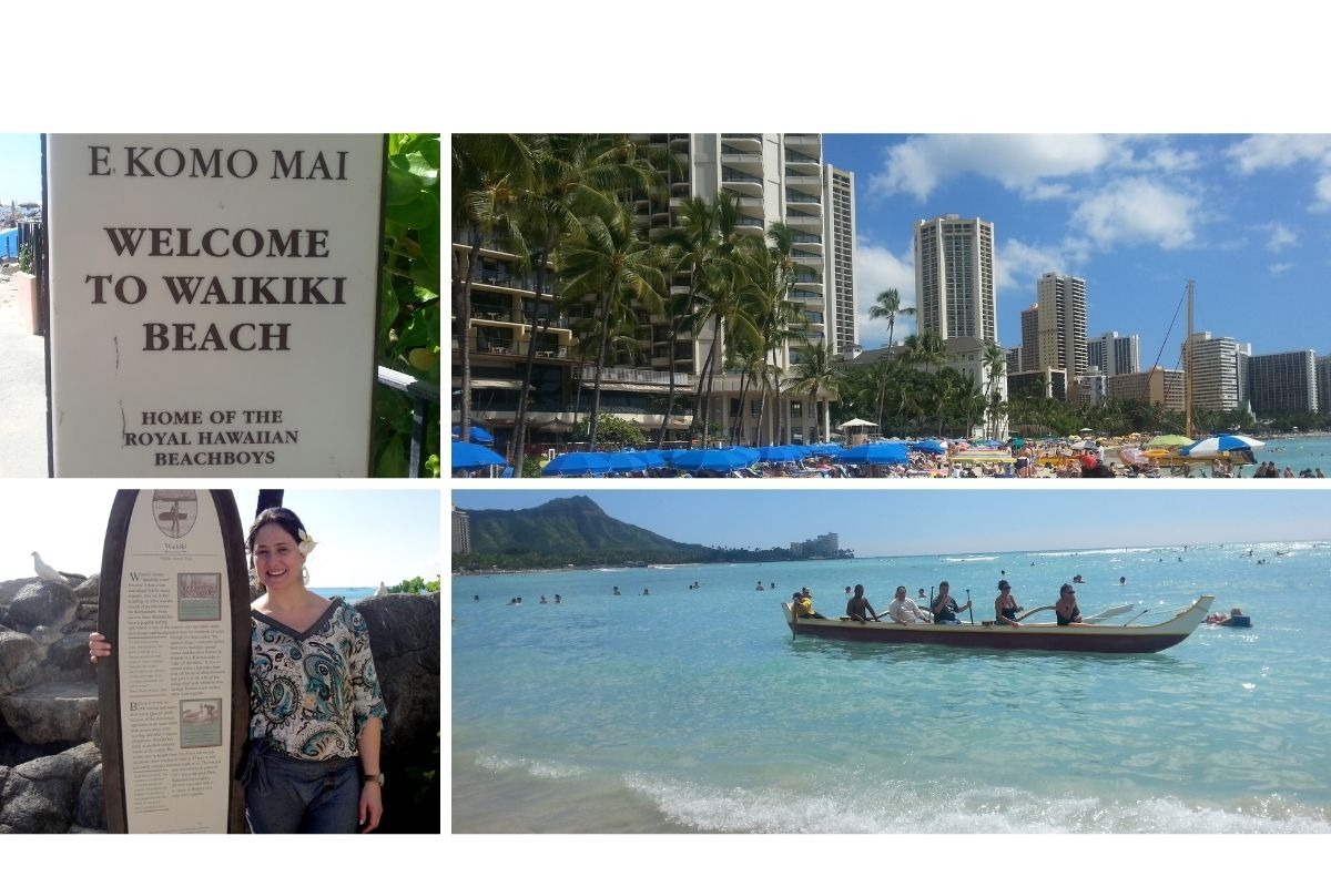 Autora na praia de Waikiki com vista da cidade de Honolulu e barco tradicional no mar
