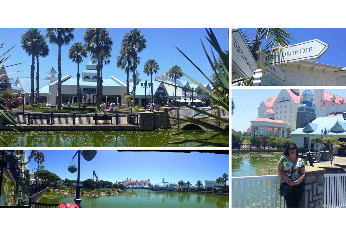 Autora explorando o Boardwalk em Port Elizabeth (Nelson Mandela Bay), com lojas, entretenimento e lago ao fundo