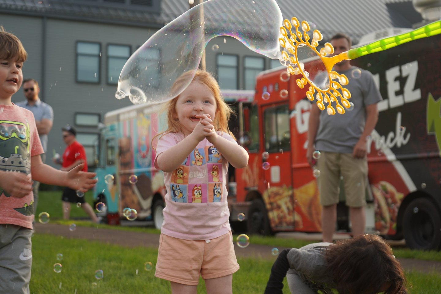 Little girl claps at the bubbles