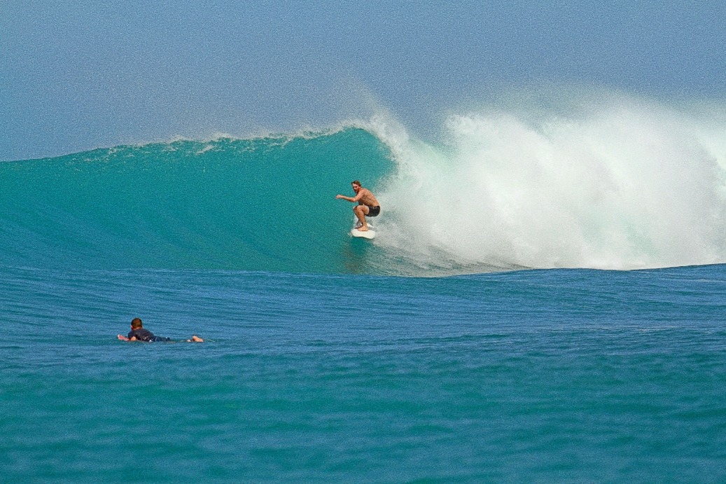 a man surfing on a wave in the ocean