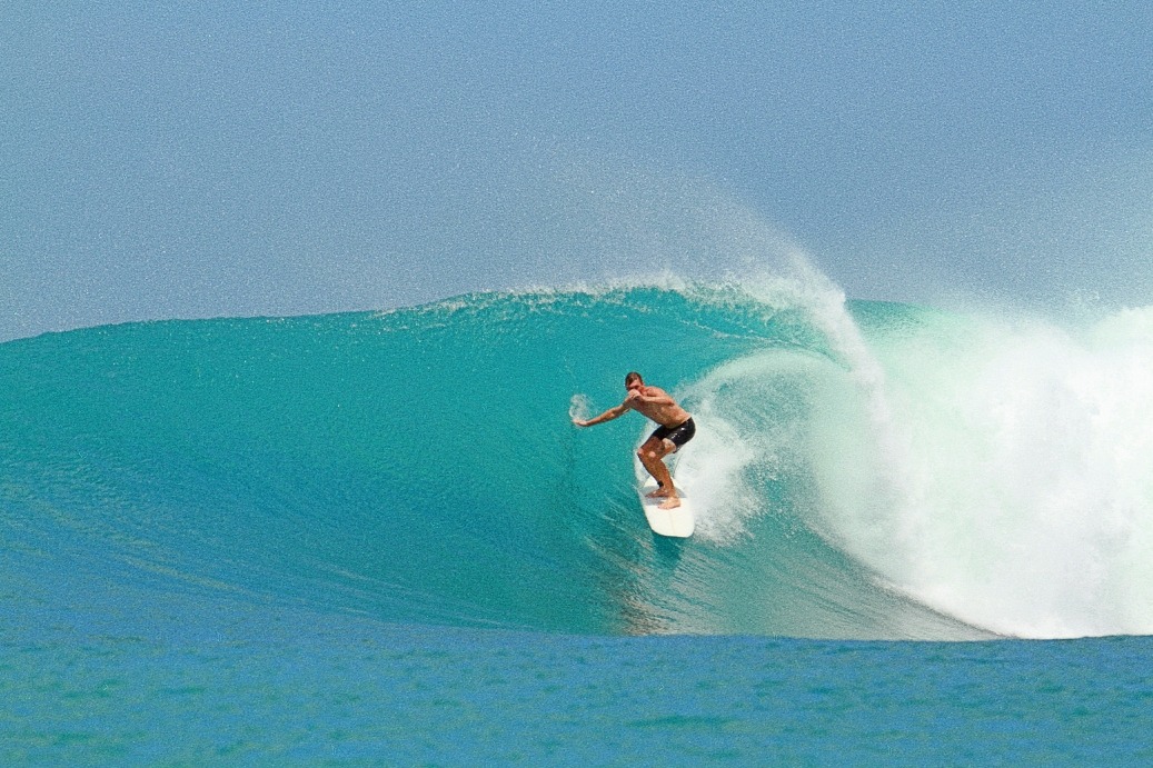 a man riding a wave in the ocean