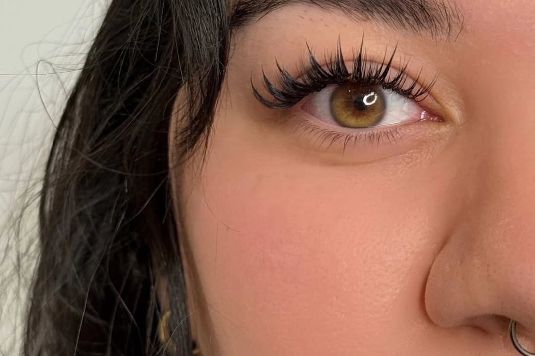 a woman with beautiful eyelashes (eyeliner) looking into the camera