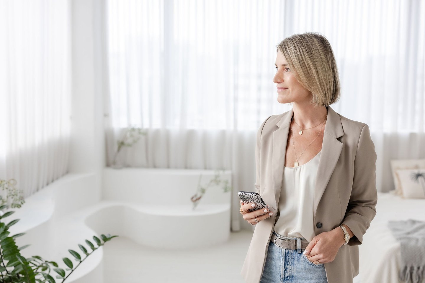 Psychotherapist Yvonne has a phone and looks to the side in a soft light