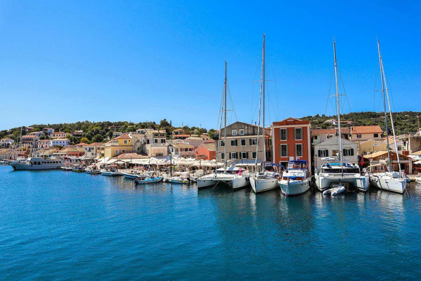 a harbor with boats and buildings in the background