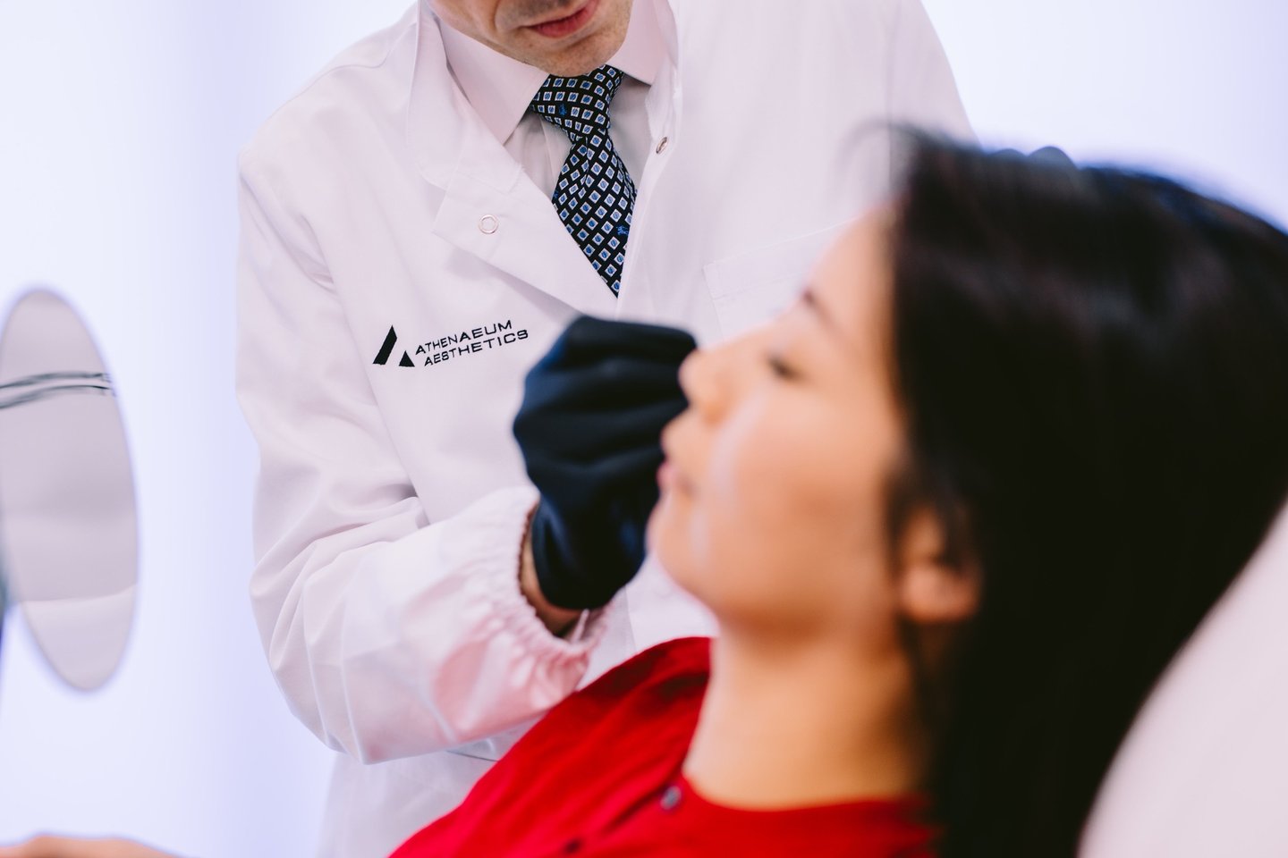 Dr Matthaios Souchlakis performing facial assessment before injectable treatment