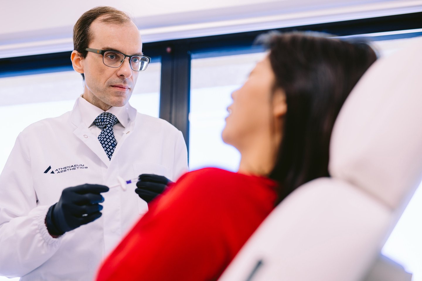 Dr Matthaios Souchlakis performing personalized patient consultation at Athenaeum Aesthetics