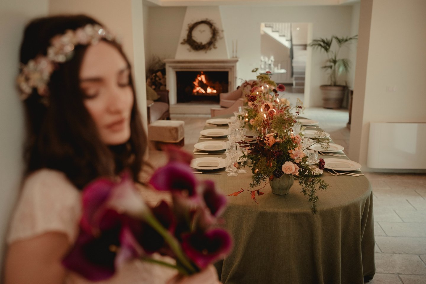a woman in a white dress is holding a bouquet