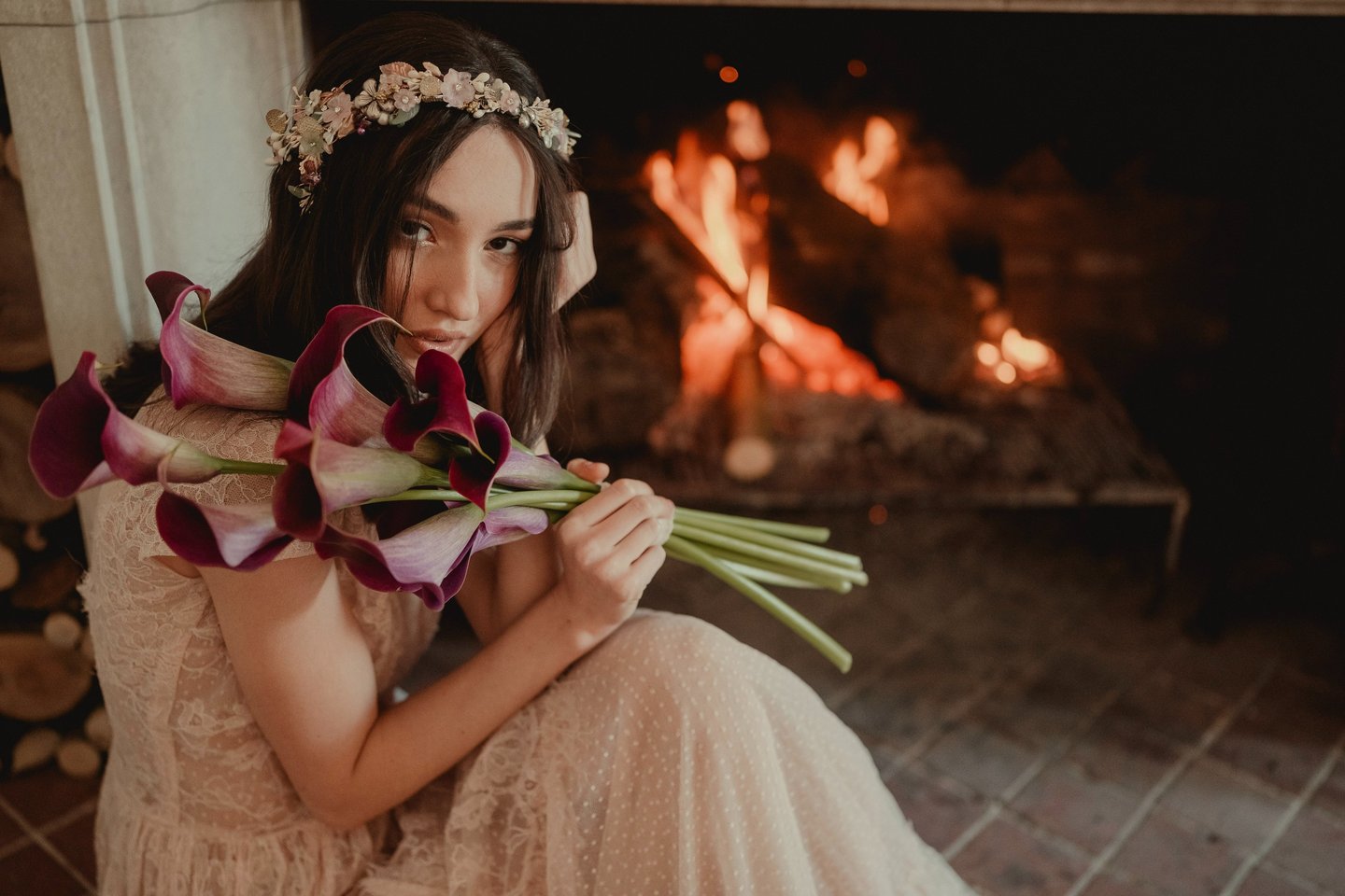 a woman in a dress with flowers in her hands