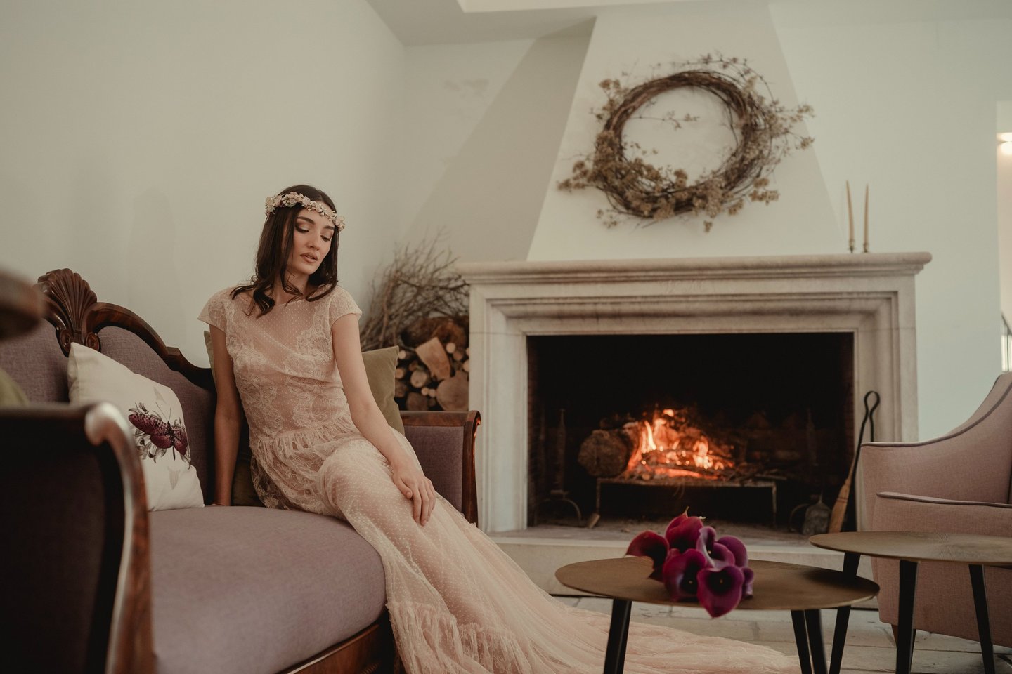 a woman in a long dress sitting on a couch