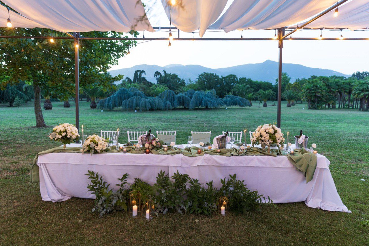 wedding table with a table cloth and candles