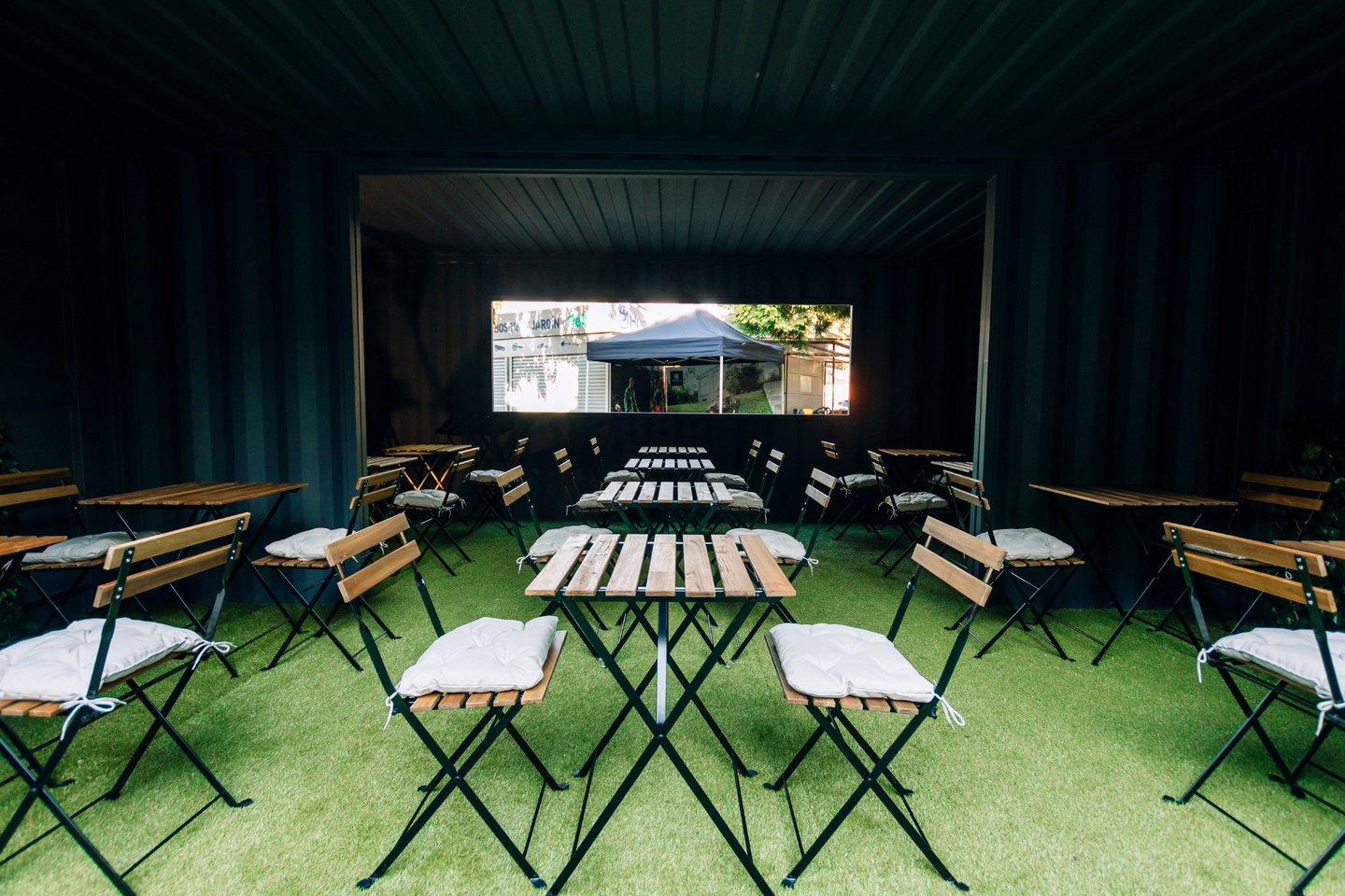 Espacio para eventos dentro de módulo contenedor con mesas y sillas