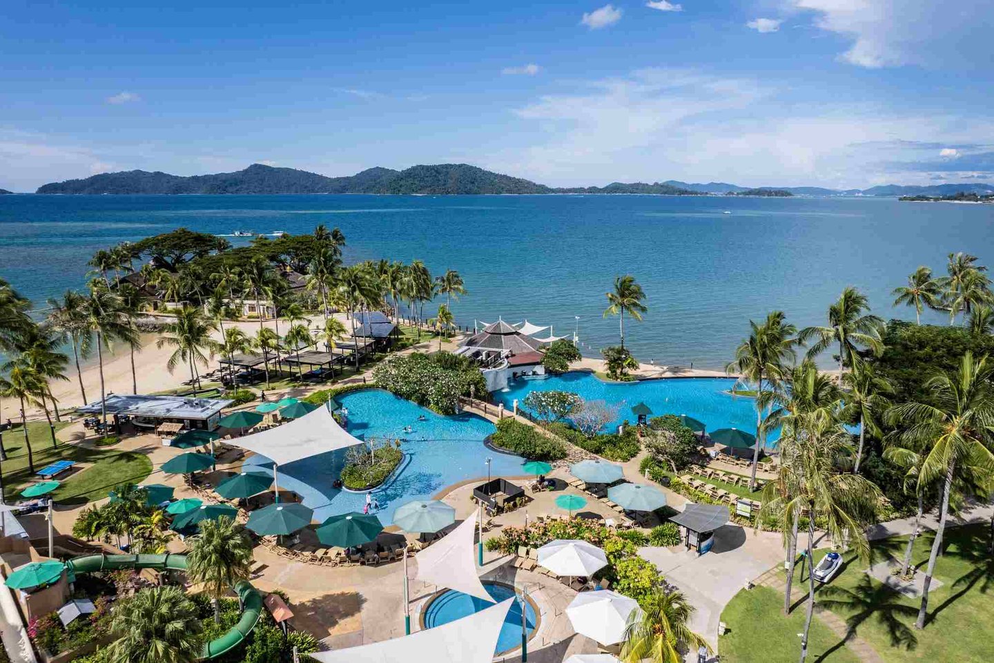 Swimming pool by the sea at Shangri-la Tanjung Aru Beach Resort