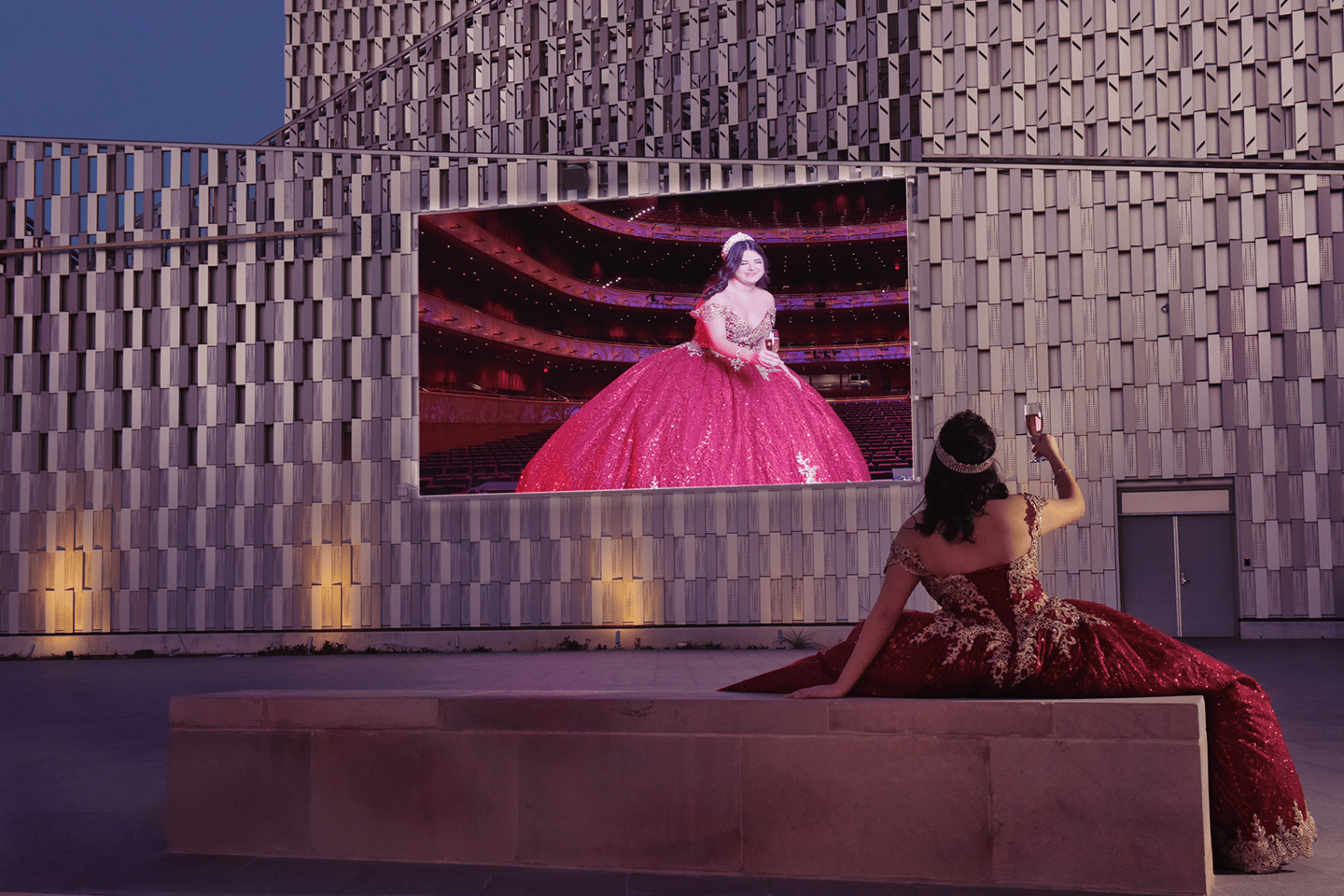 a woman in a red quinceanera dress sitting on a bench