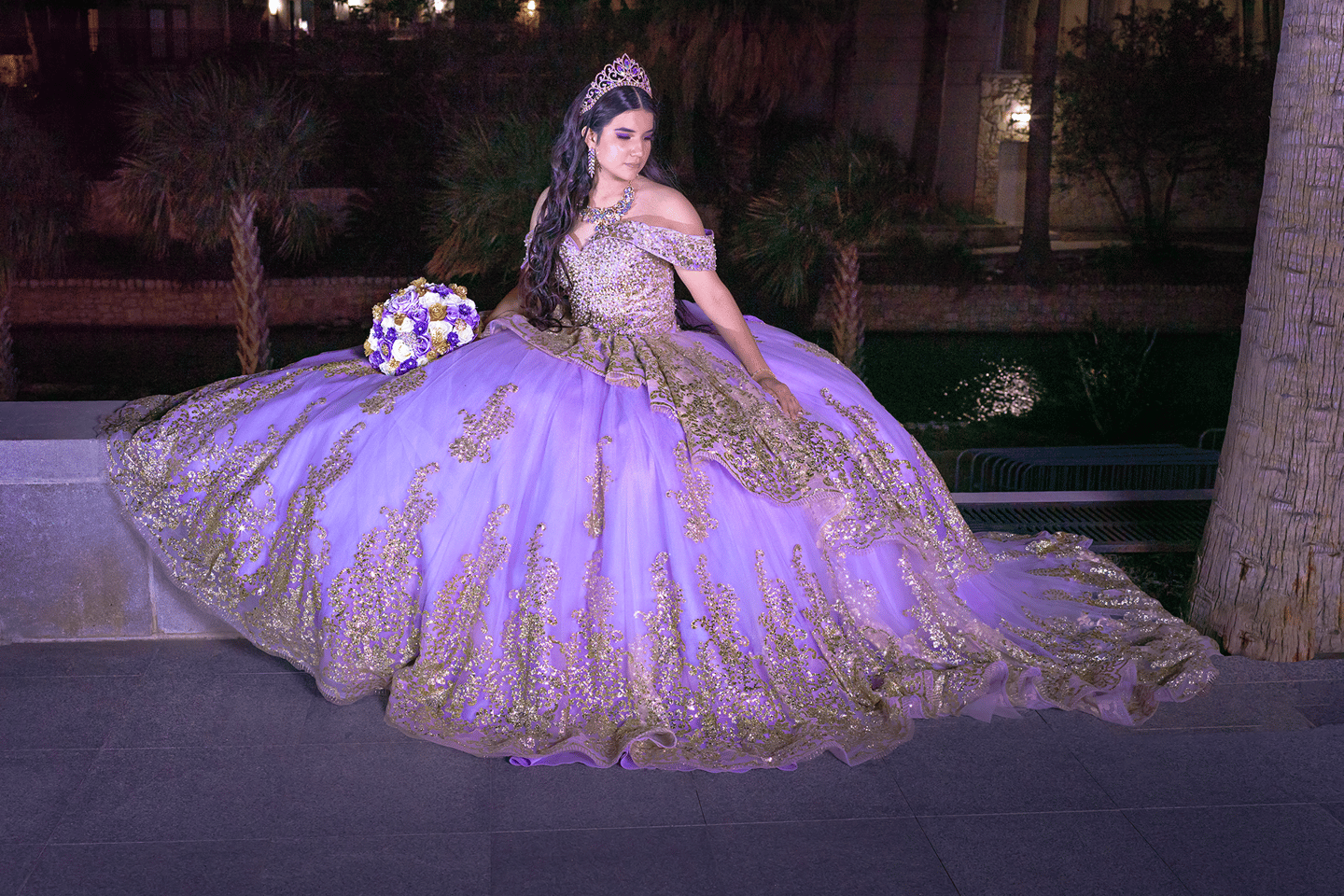 a woman in a purple dress sitting on a bench