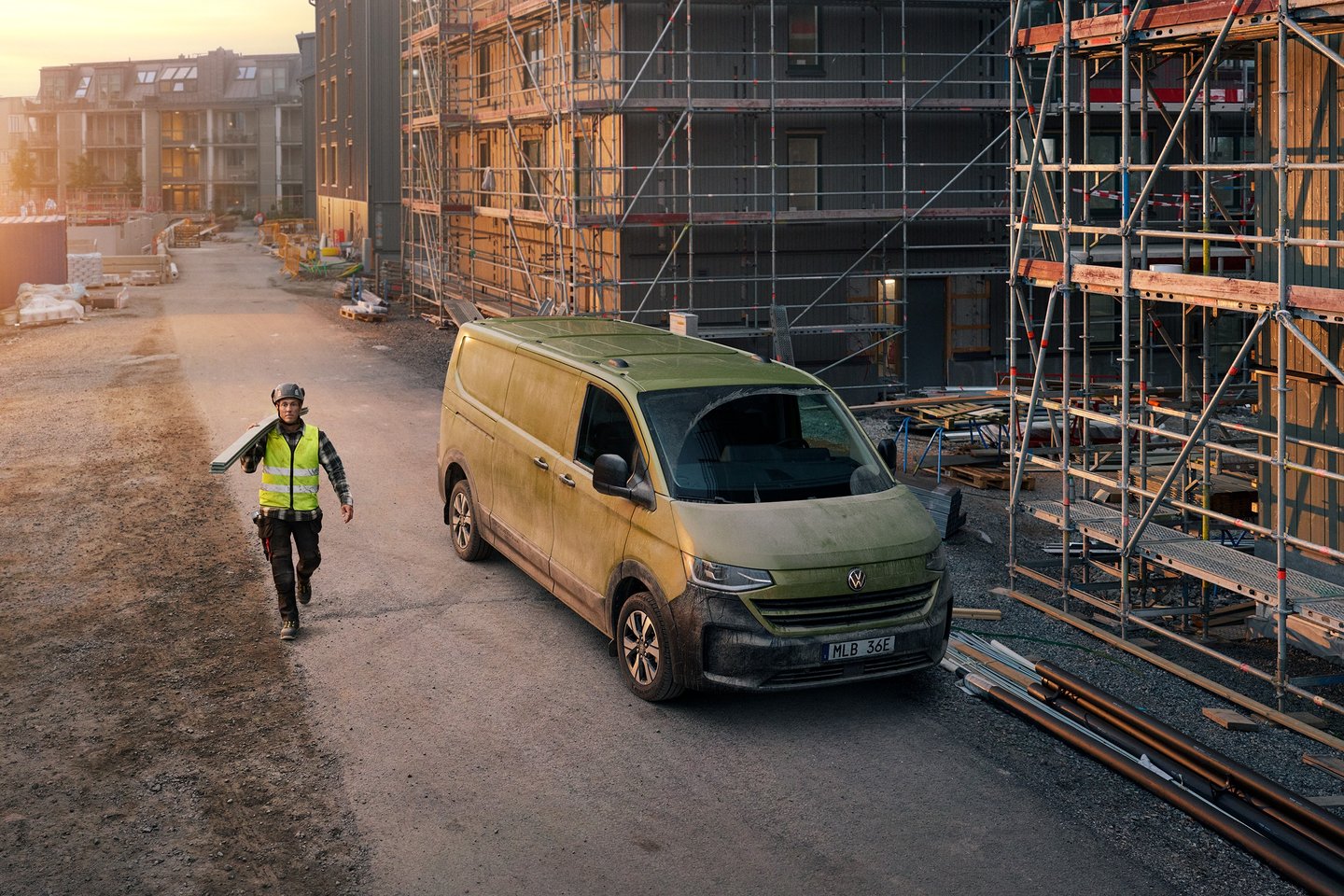 Construction worker beside a green VW Transporter in a national advertising campaign
