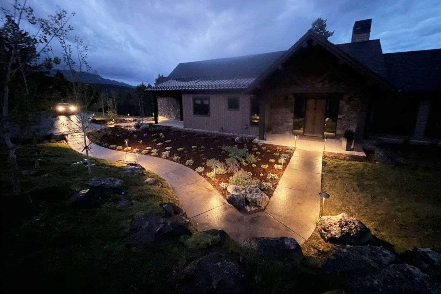 a house with a pathway leading to a driveway