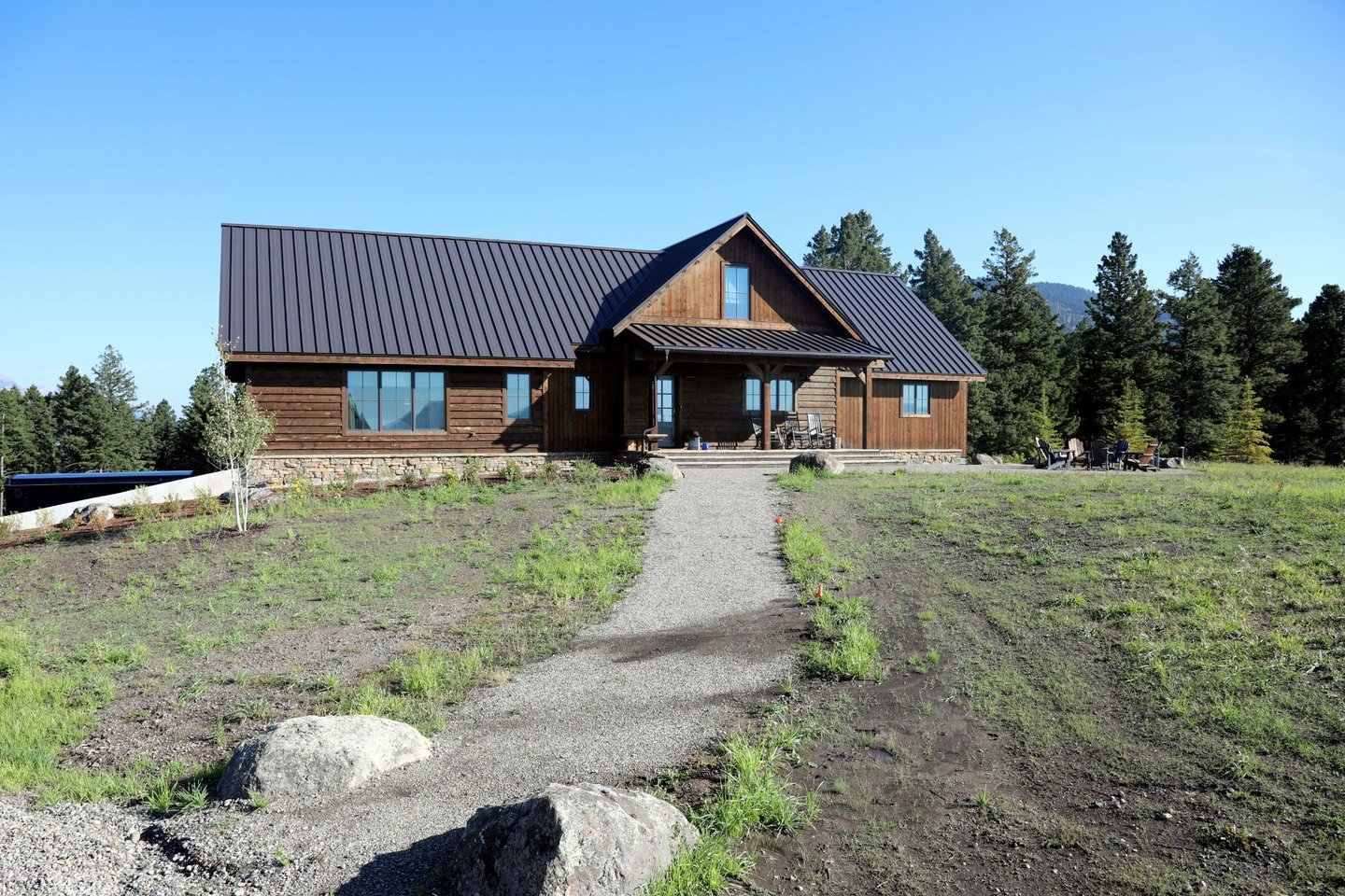 a house with a brown metal roof and a brown metal roof