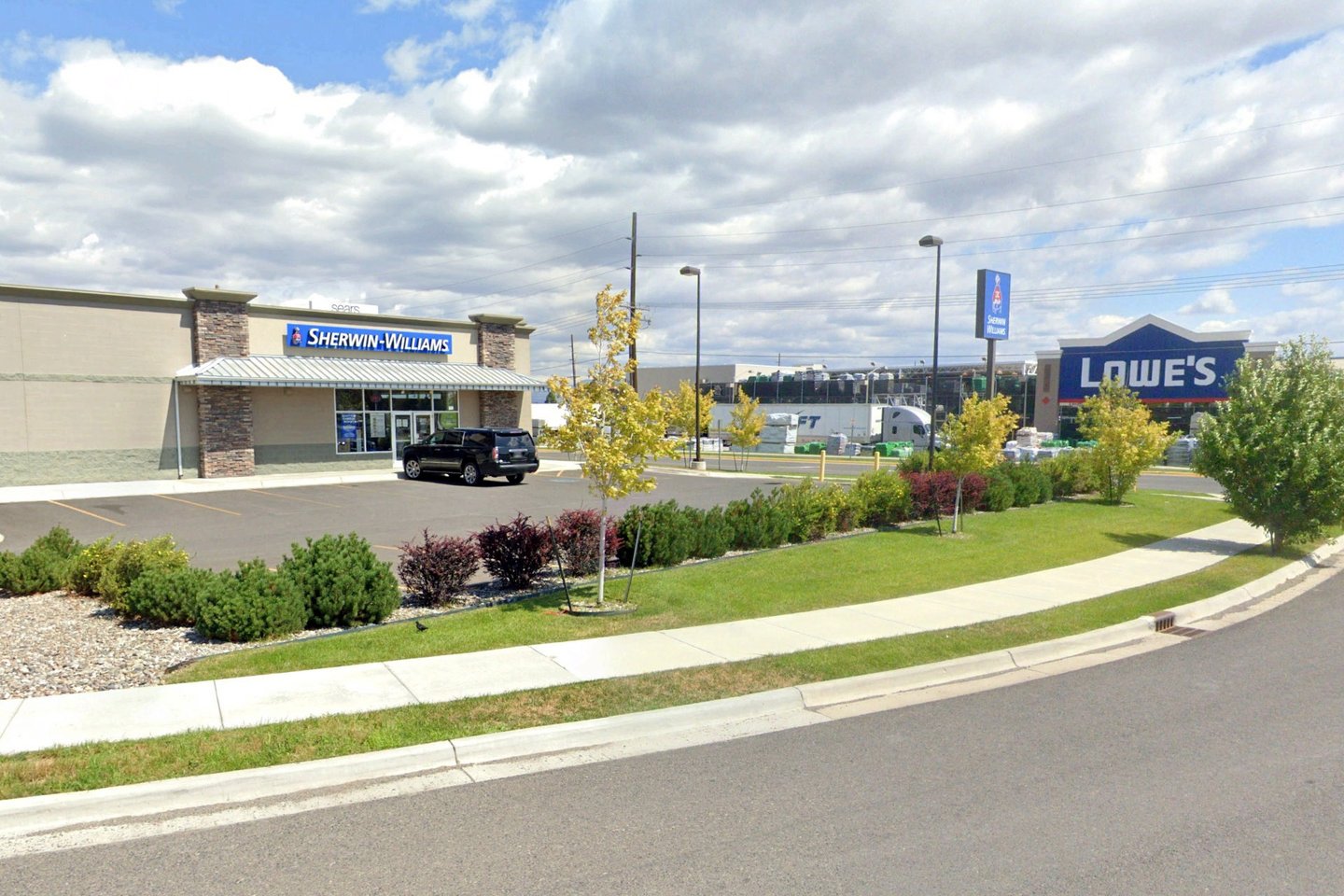 a car dealership with a truck parked in front of it