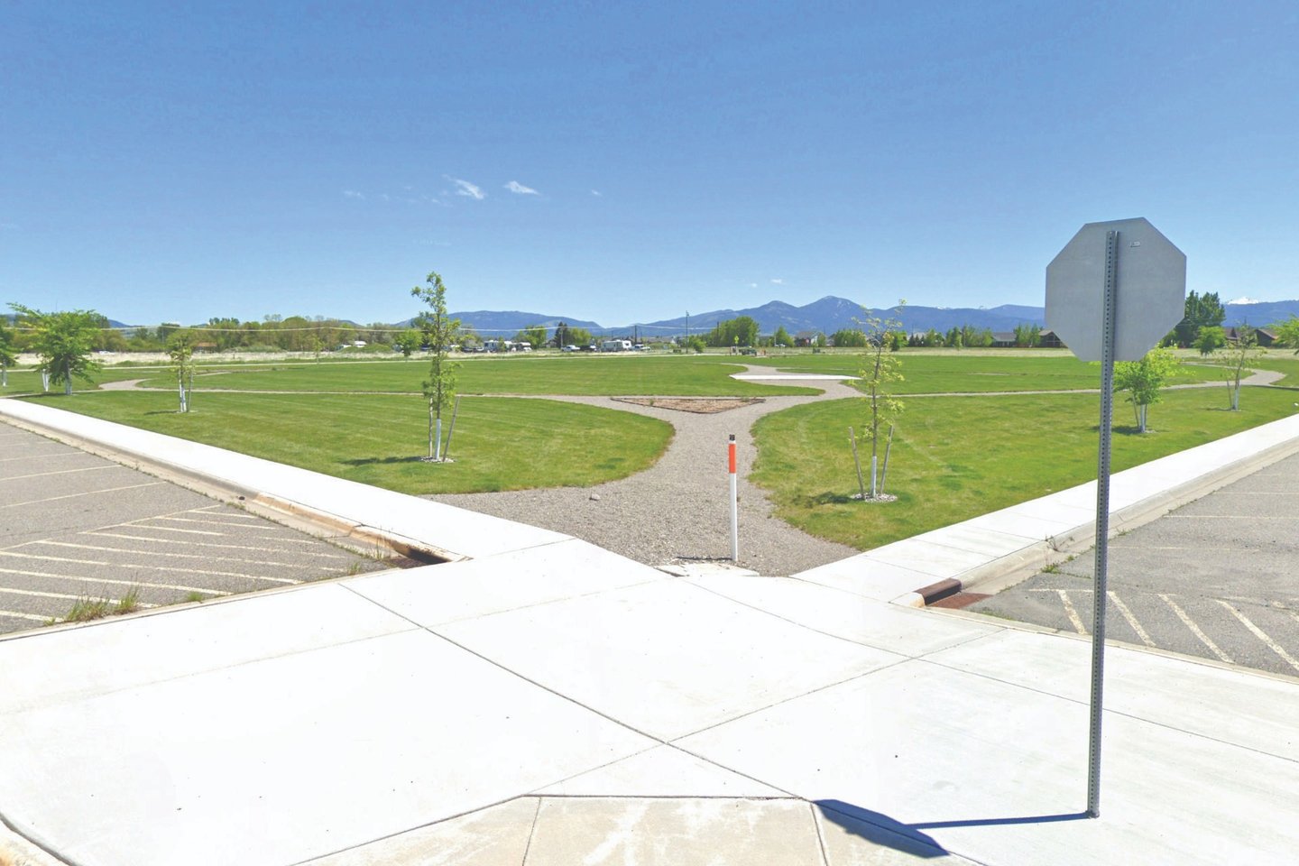 a stop sign on a street corner with a view of mountains in the background