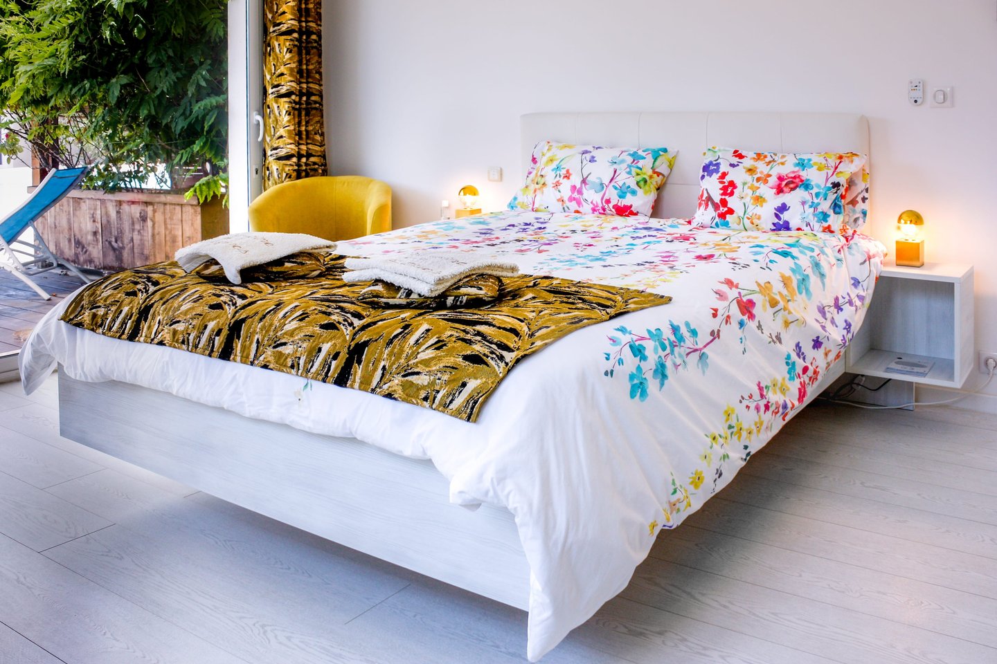 Bed with full bedding, floating bed with two with swimming pool in flower colours at Domaine Des Lucques