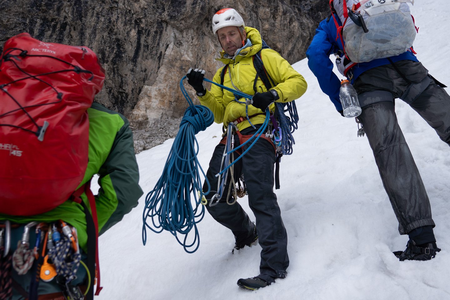 Climber Timmy Oneill prepares a rope for descent in a steep gully in the Italian Dolomites