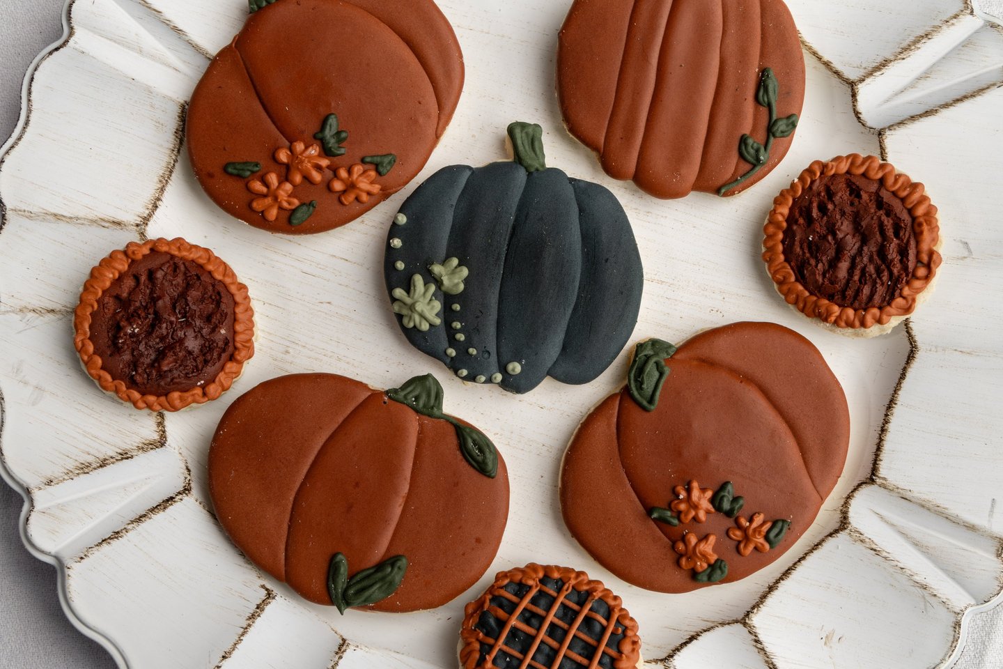 warm but dark themed fall cookies. pumpkins and flowers with rich dark colors