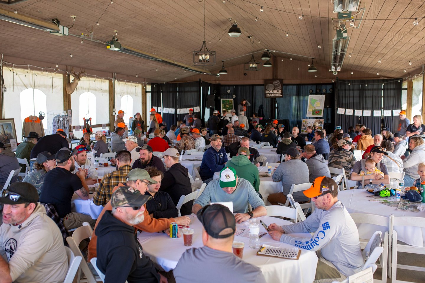 View of participants sitting at tables after a round of sporting clays.