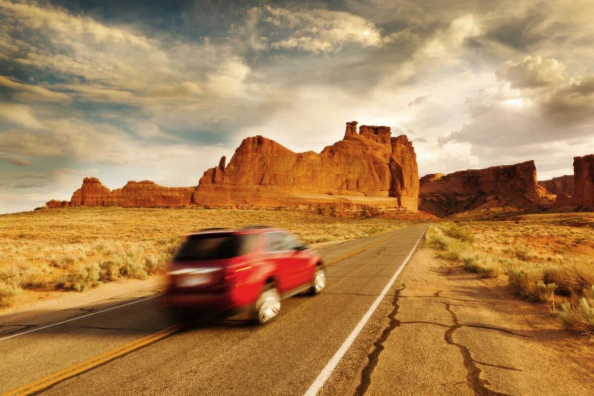 SUV speeding through desert landscape – embodying affordable cars Four Corners SUV on open roads