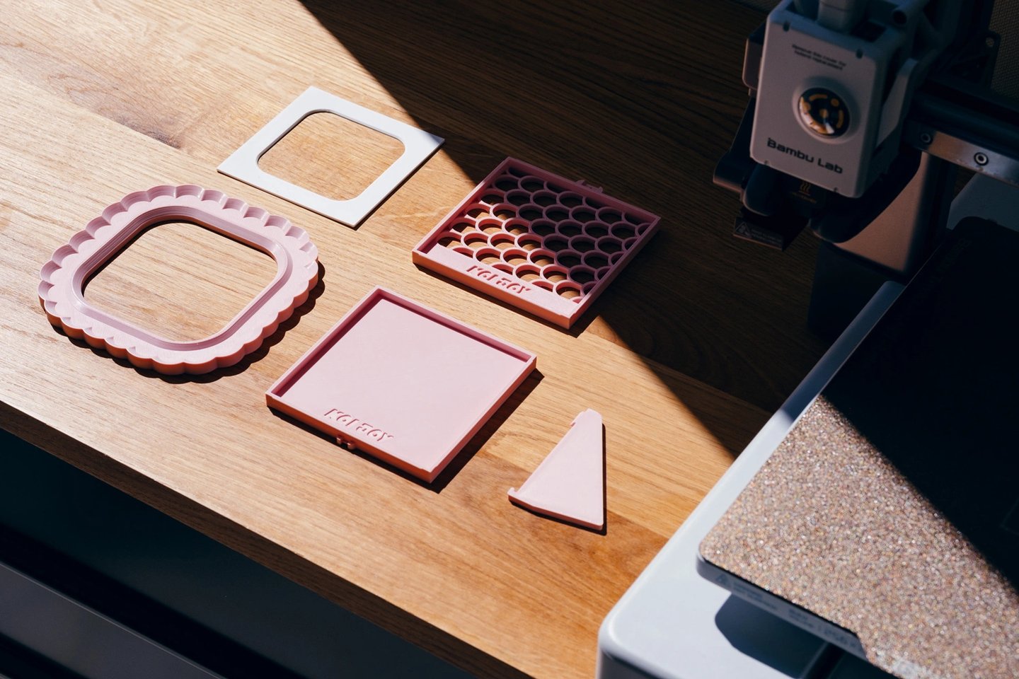 3D printable photo frame parts printing on desk, modular minimal frame design