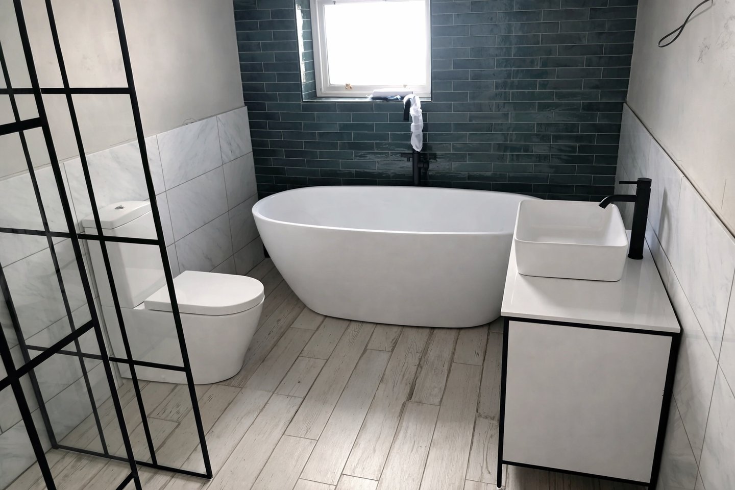 Contemporary bathroom with freestanding bath and dark feature tiles in Brighton home renovation.