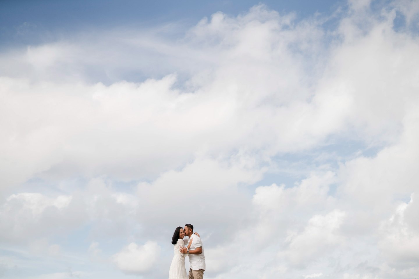 Ayunda family silhouette moment captured against the sky at Melasti Beach Bali.