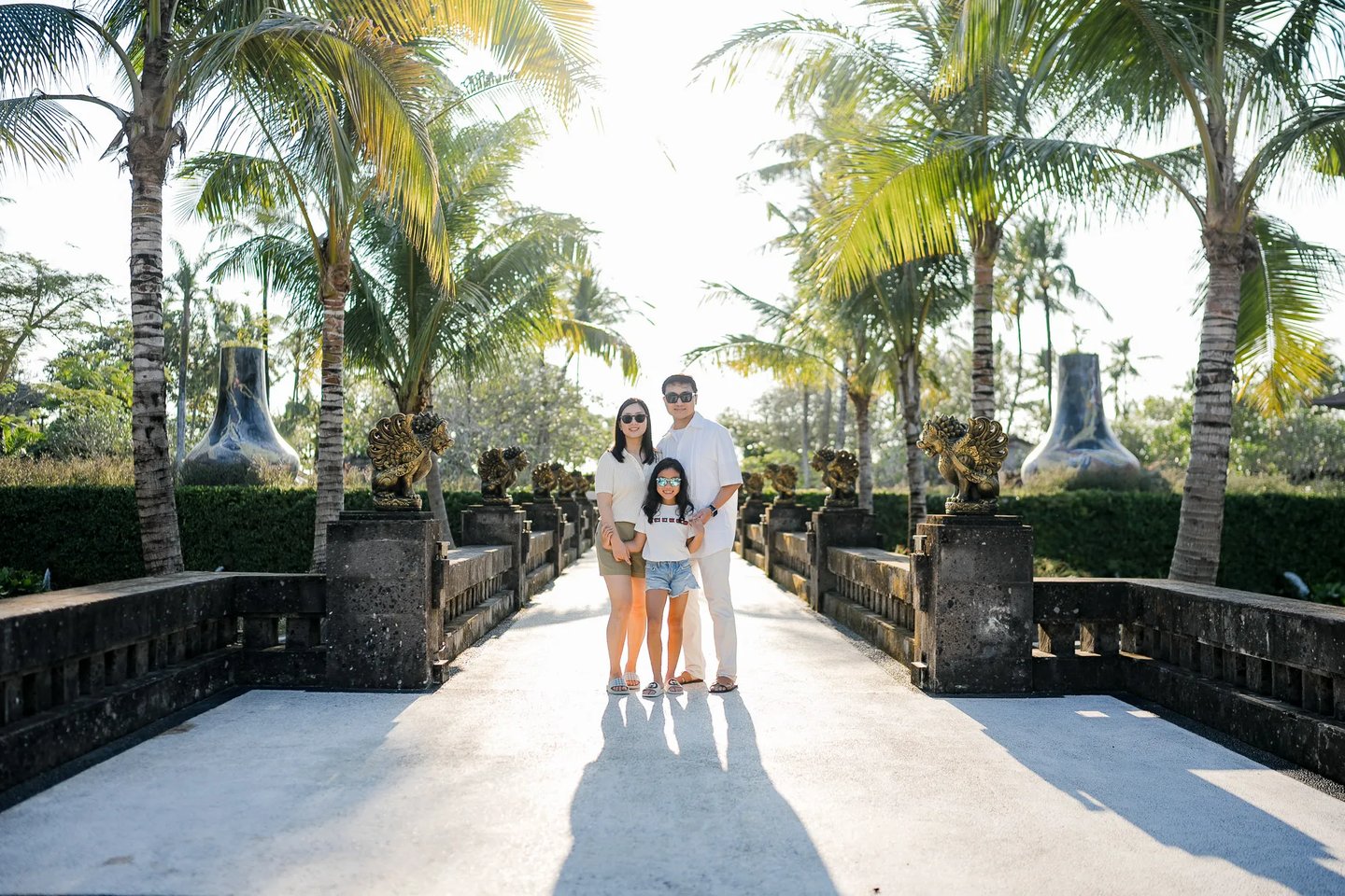 Family portrait captured along a garden pathway at InterContinental Bali Resort Bali