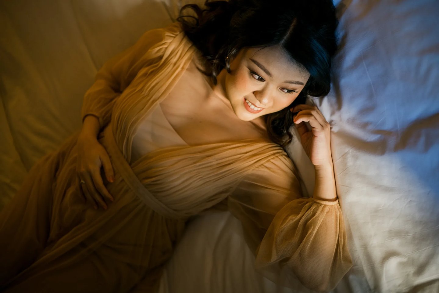 Elegant maternity portrait inside a luxury suite at The Apurva Kempinski Bali