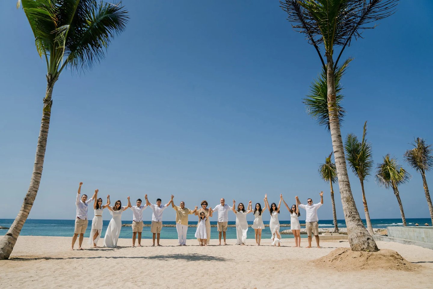 Multi-generation family portrait on the private beach at The Apurva Kempinski Bali
