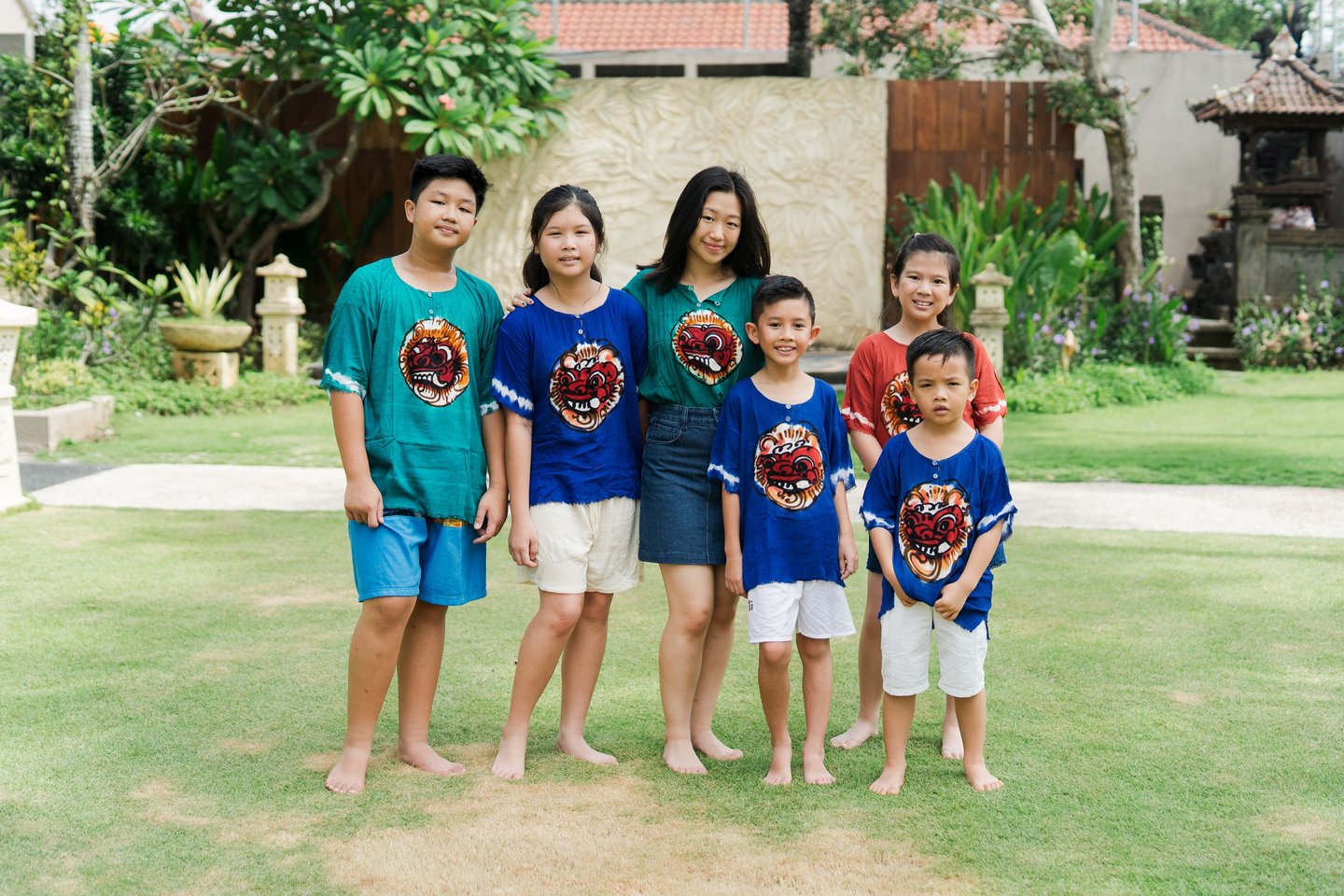 Extended family session at Lumbini Villas Jimbaran showing parents and children standing together in a relaxed outdoor 