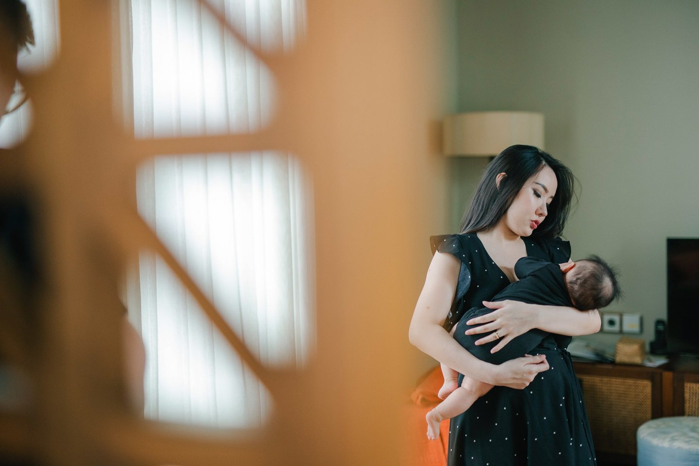 Mother holding baby during a family photography session at a private villa in Ubud Bali.