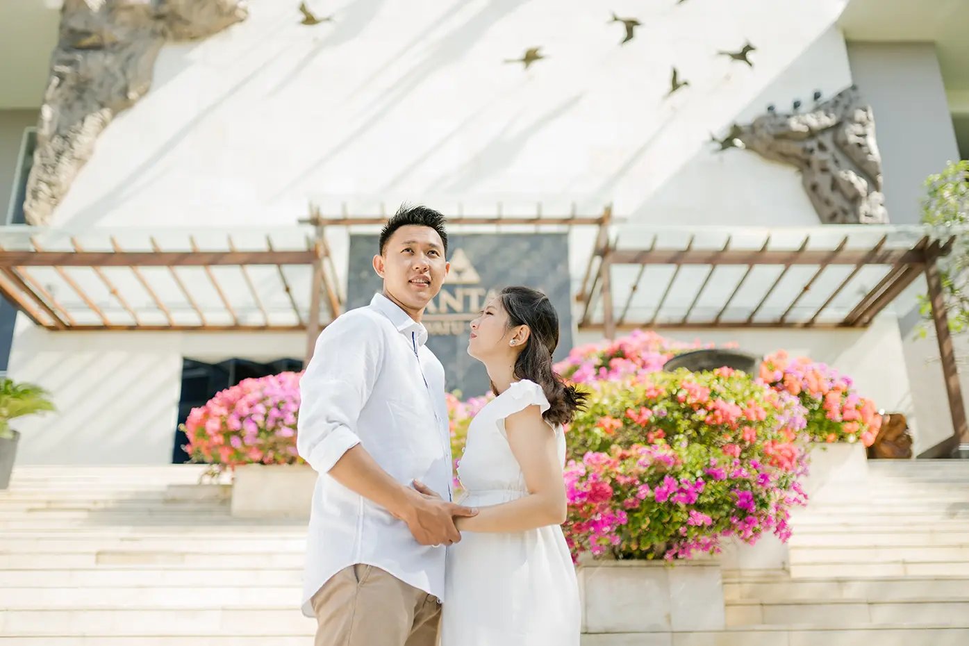 Couple sharing a quiet maternity moment during a family photography session at Anantara Uluwatu.