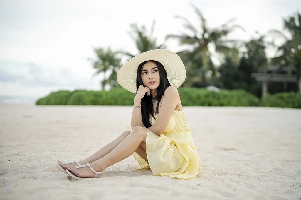 Elegant woman's beach portrait at The Apurva Kempinski Bali