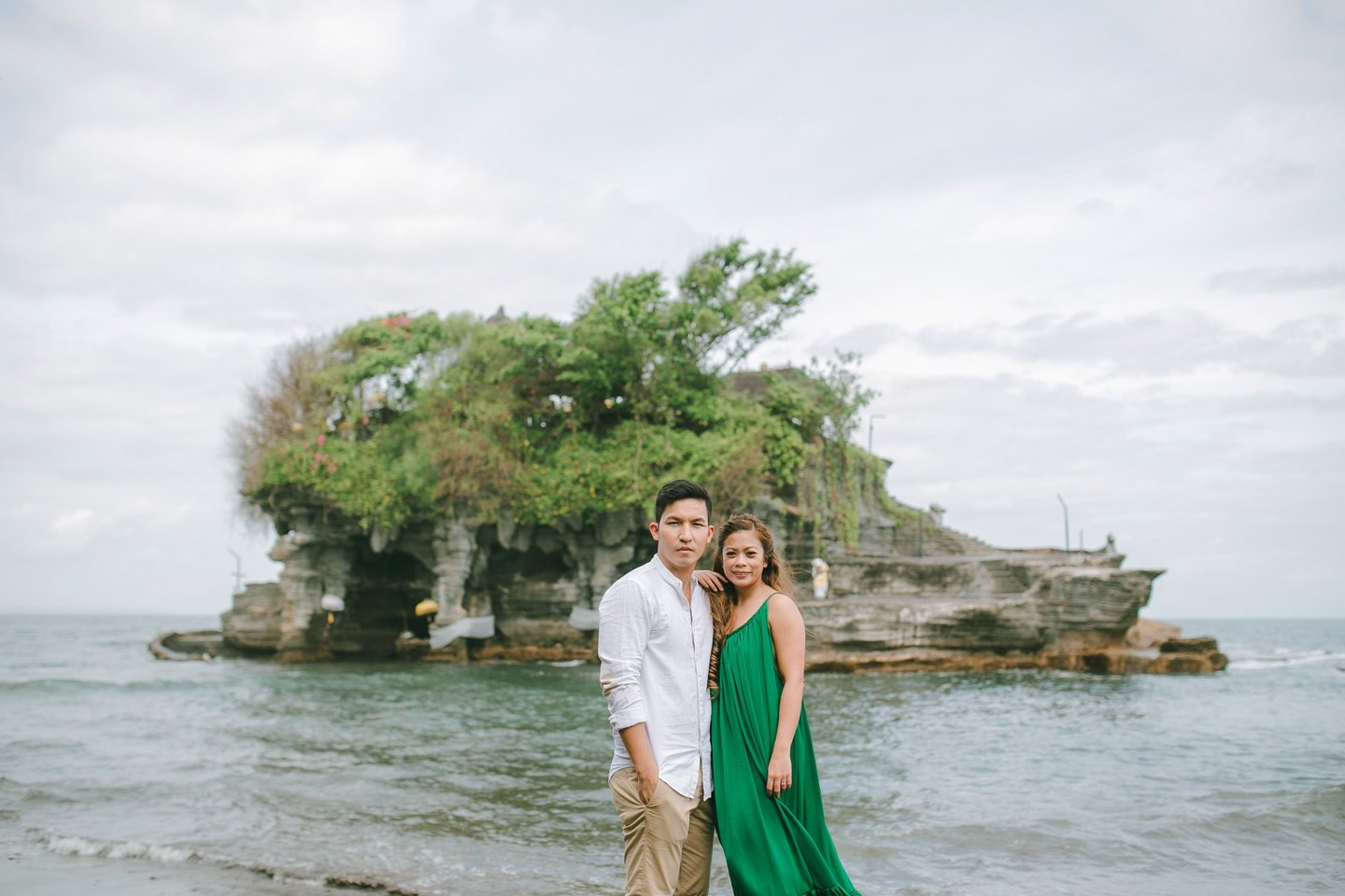 Wide scenic portrait of an intimate couple at Tanah Lot Bali.