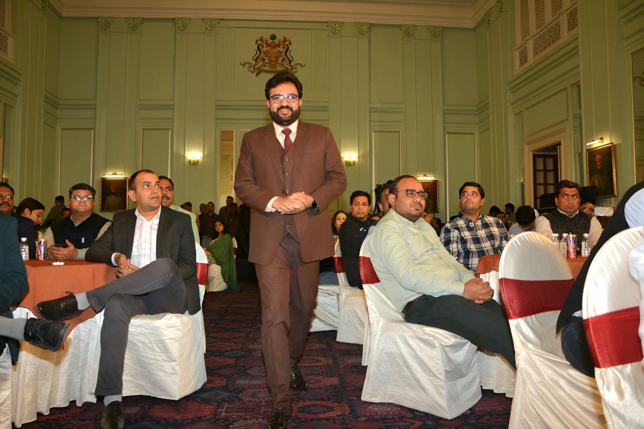 Speaker addressing an engaged audience at a formal event.