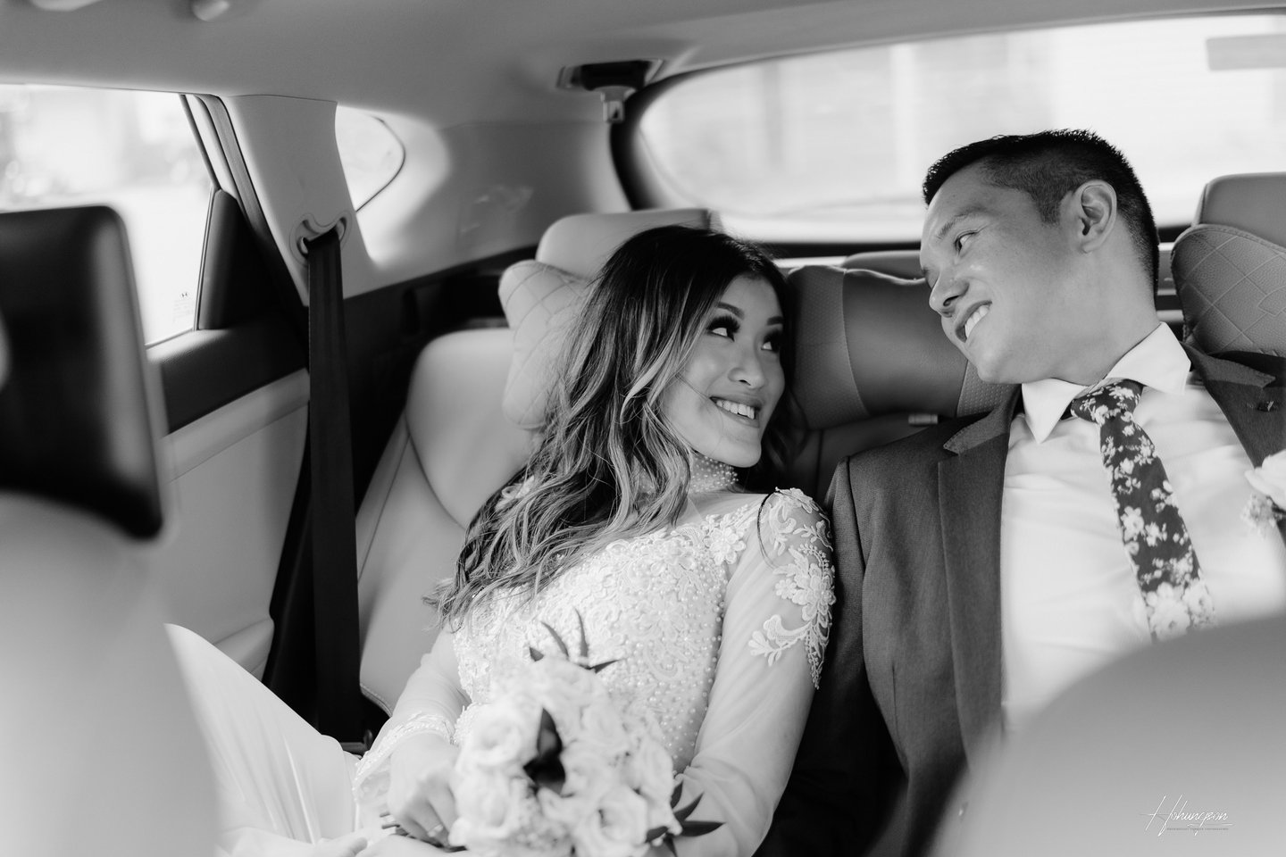 a bride and groom in a car